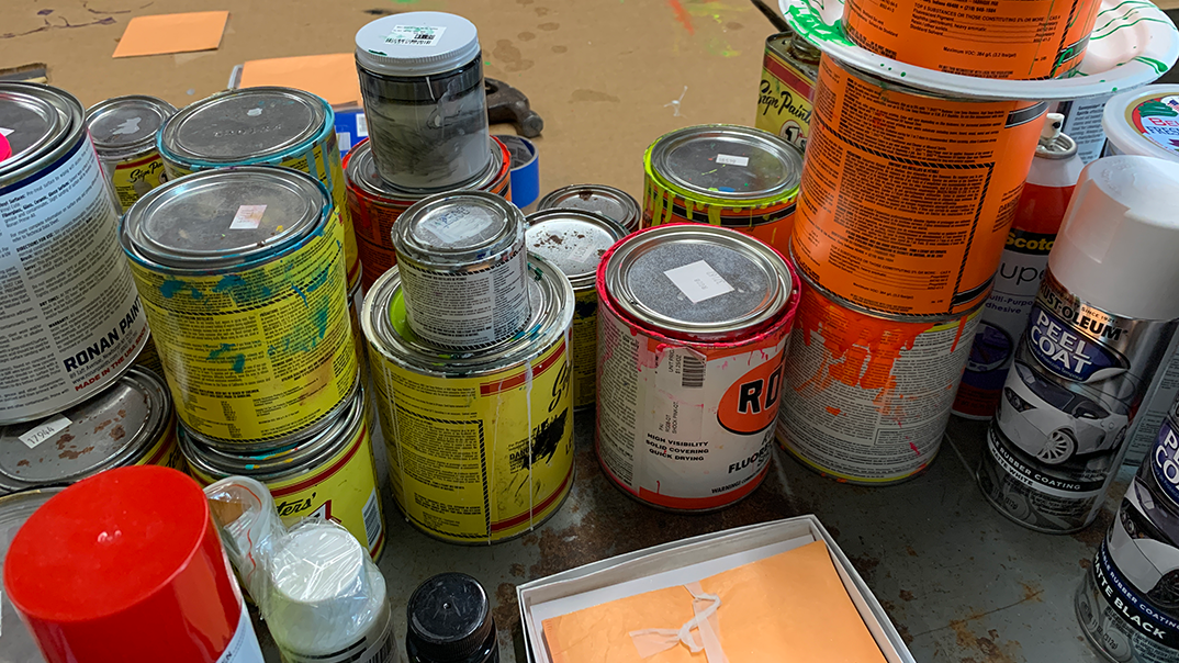 Multiple paint cans on floor