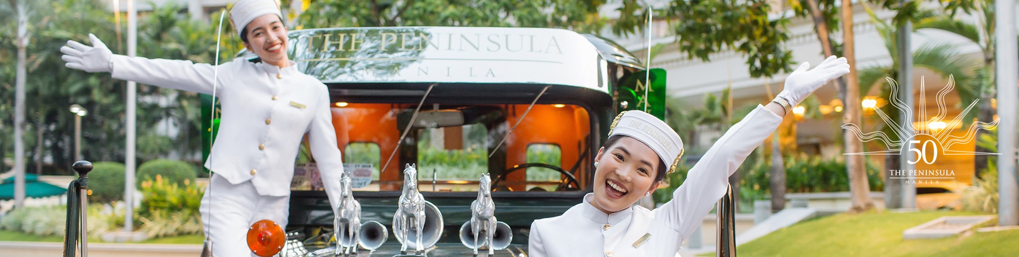 Pen Page welcoming guest by standing at The Peninsula Manila Jeepney